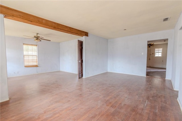 spare room with hardwood / wood-style floors, beamed ceiling, and ceiling fan