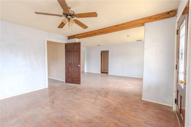 empty room featuring beamed ceiling, wood-type flooring, and ceiling fan