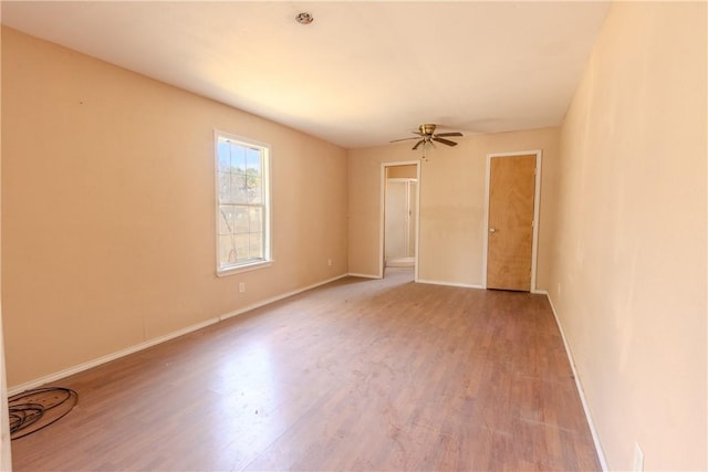 unfurnished room with ceiling fan and wood-type flooring