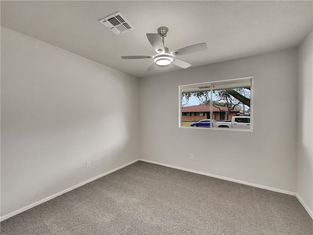 carpeted empty room featuring baseboards, visible vents, and ceiling fan