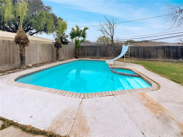 view of pool with a fenced backyard, a pool with connected hot tub, a water slide, and a patio