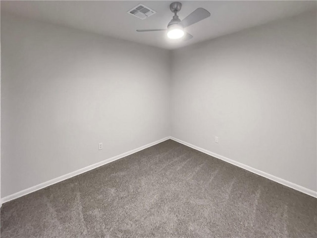 unfurnished room with visible vents, baseboards, dark colored carpet, and a ceiling fan