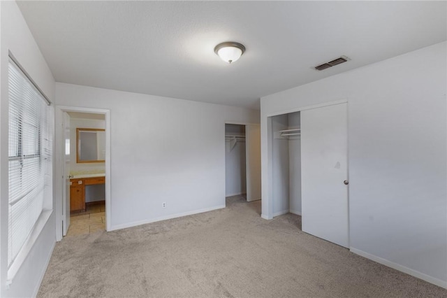 unfurnished bedroom with light colored carpet