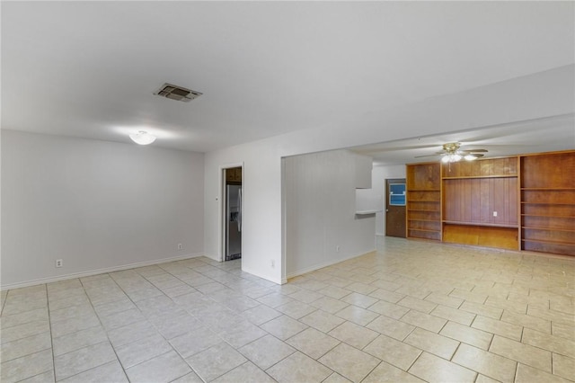 tiled empty room with ceiling fan