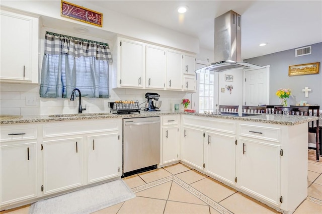 kitchen featuring a sink, white cabinets, a peninsula, stainless steel dishwasher, and island range hood