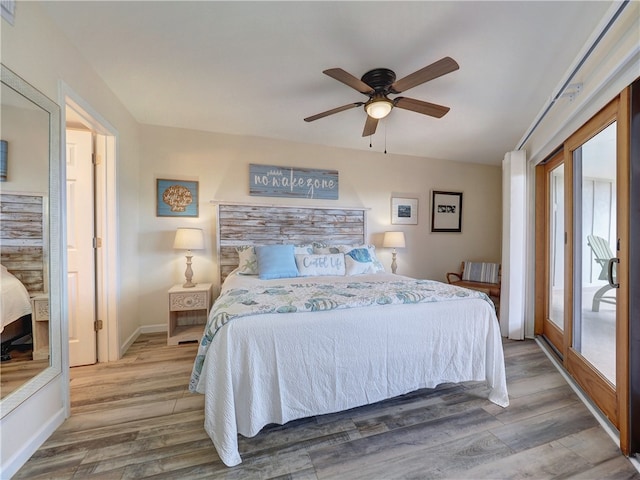 bedroom with access to outside, wood-type flooring, and ceiling fan