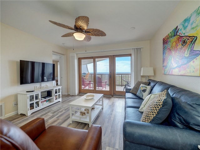 living room with light hardwood / wood-style floors and ceiling fan