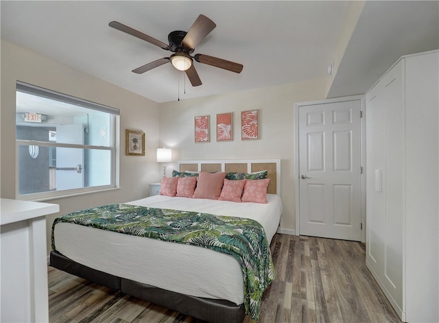 bedroom with hardwood / wood-style flooring and ceiling fan