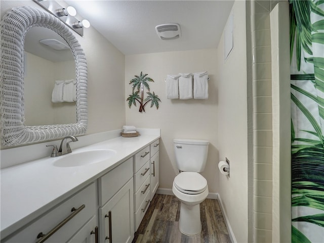 bathroom with walk in shower, wood-type flooring, vanity, and toilet