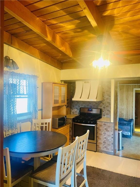 kitchen featuring appliances with stainless steel finishes, wooden ceiling, custom range hood, and beamed ceiling