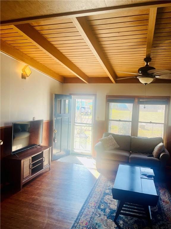 living area featuring wood ceiling, a healthy amount of sunlight, beamed ceiling, and wood finished floors