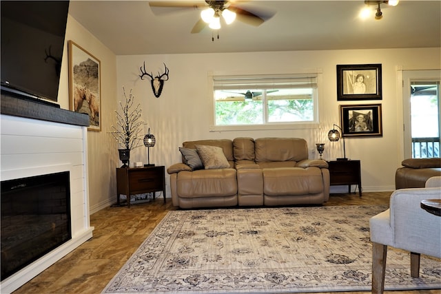 living room featuring a wealth of natural light and ceiling fan