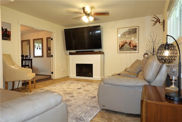 living room featuring ceiling fan and light hardwood / wood-style flooring