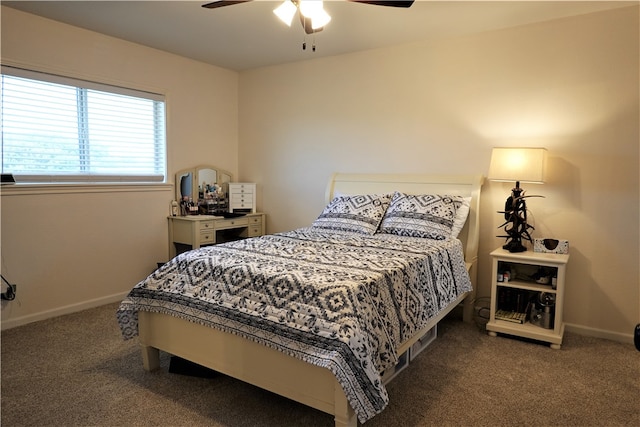 bedroom with dark colored carpet and ceiling fan