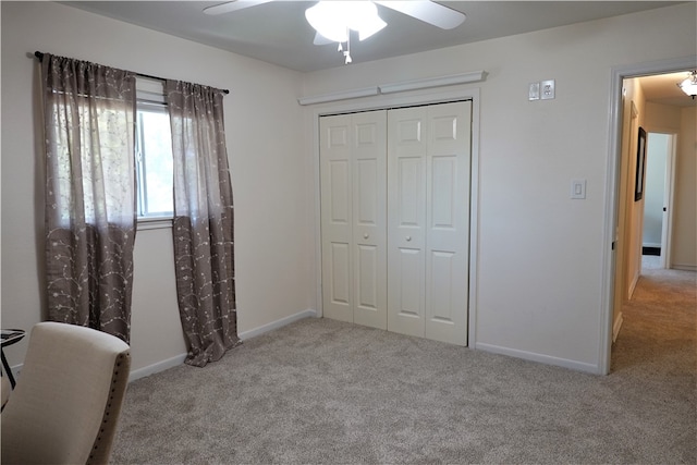 carpeted bedroom featuring a closet and ceiling fan