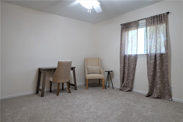 office area featuring light carpet and ceiling fan