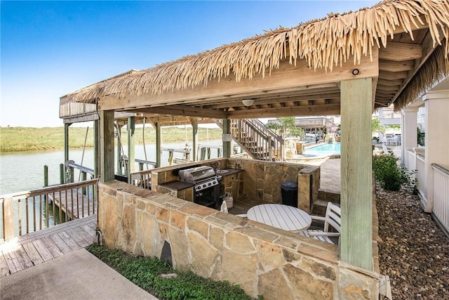 14890 Granada Dr Unit 102, Corpus Christi, TX 78418 - dock featuring boat lift, a water view, and an outdoor pool