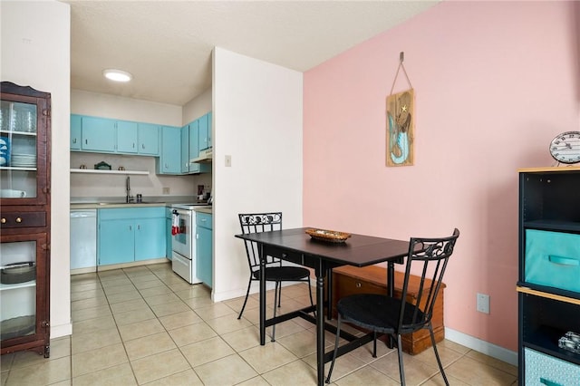 715 S Upper Broadway St Unit 404, Corpus Christi, TX 78401 - kitchen featuring white appliances, blue cabinets, under cabinet range hood, light tile patterned flooring, and light countertops