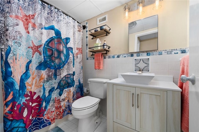 715 S Upper Broadway St Unit 404, Corpus Christi, TX 78401 - bathroom featuring tile walls, vanity, tile patterned flooring, a wainscoted wall, and a shower with curtain