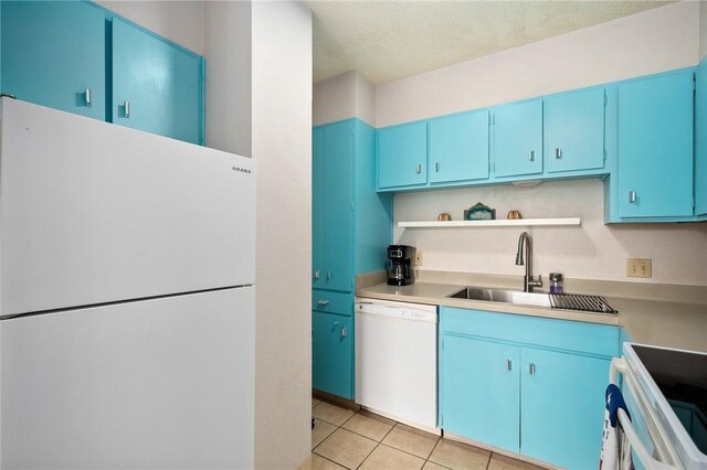 715 S Upper Broadway St Unit 404, Corpus Christi, TX 78401 - kitchen featuring white appliances, blue cabinets, open shelves, light tile patterned floors, and light countertops