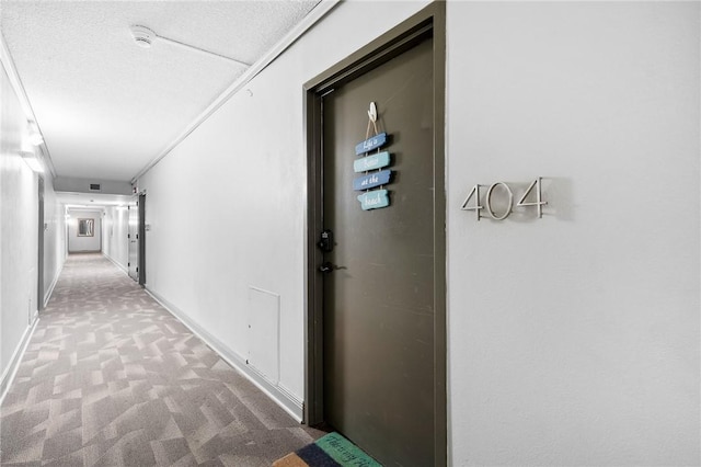 715 S Upper Broadway St Unit 404, Corpus Christi, TX 78401 - hallway featuring carpet floors and a textured ceiling