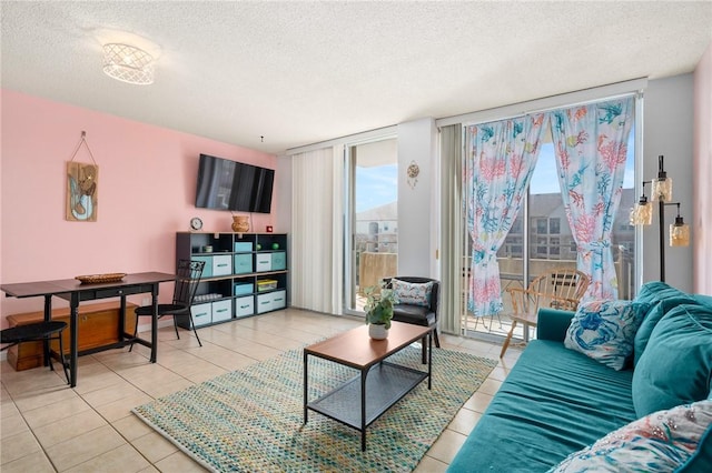 715 S Upper Broadway St Unit 404, Corpus Christi, TX 78401 - living area featuring a textured ceiling, light tile patterned floors, and healthy amount of natural light
