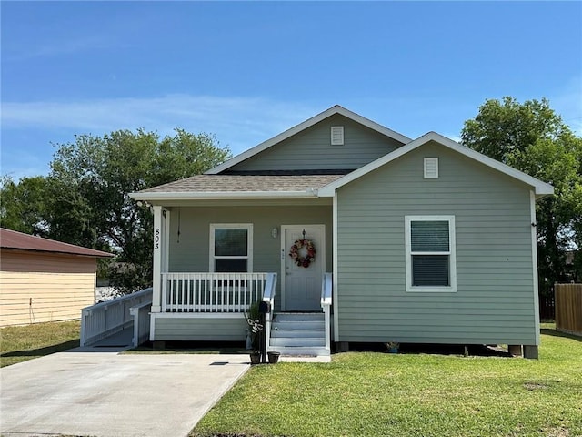 803 Molina St, Robstown, TX 78380 - view of front of house featuring a front lawn, covered porch, and a shingled roof
