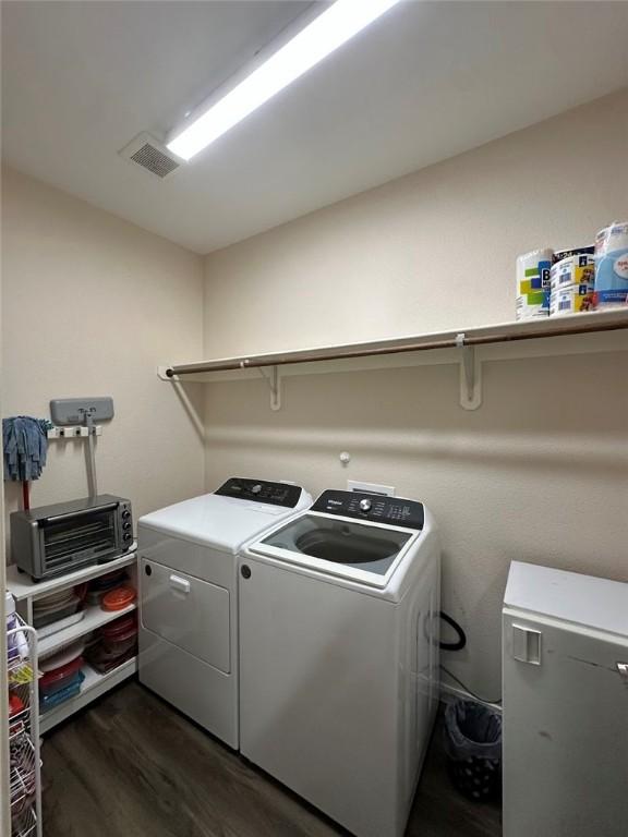 803 Molina St, Robstown, TX 78380 - clothes washing area featuring dark wood finished floors and washing machine and dryer
