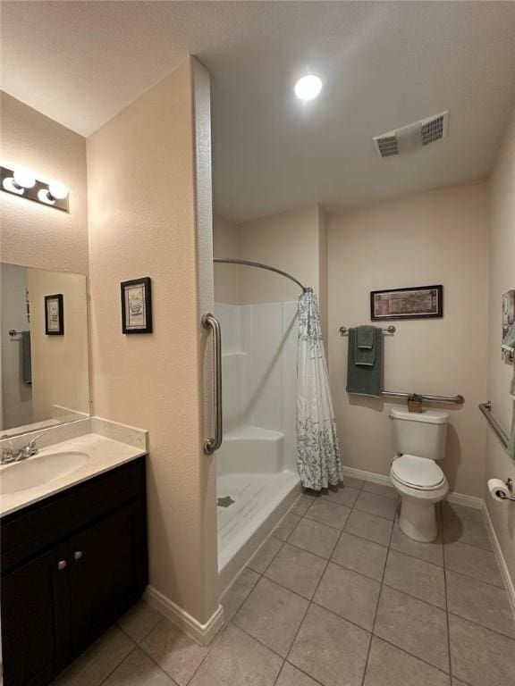 803 Molina St, Robstown, TX 78380 - full bath with a stall shower, tile patterned floors, vanity, and toilet