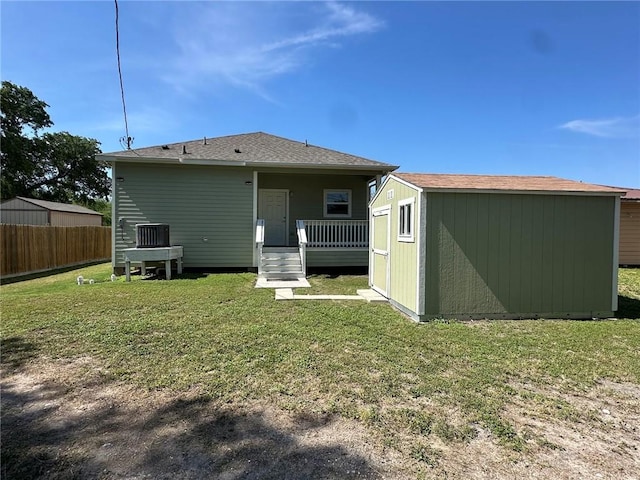 803 Molina St, Robstown, TX 78380 - rear view of property with an outdoor structure, a shed, and a deck