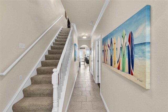 14901 Windward Dr Unit 704, Corpus Christi, TX 78418 - stairs featuring tile patterned floors, baseboards, arched walkways, and crown molding