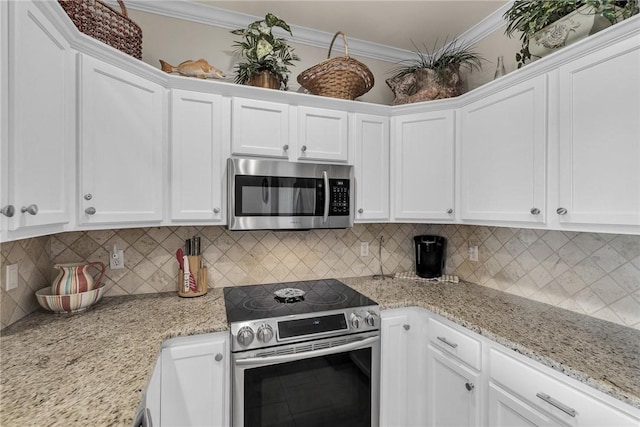 14901 Windward Dr Unit 704, Corpus Christi, TX 78418 - kitchen featuring ornamental molding, light stone countertops, white cabinetry, and stainless steel appliances
