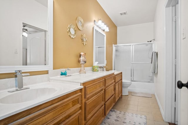 full bathroom featuring vanity, combined bath / shower with glass door, tile patterned floors, and toilet