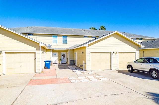 view of front facade with central AC and a garage