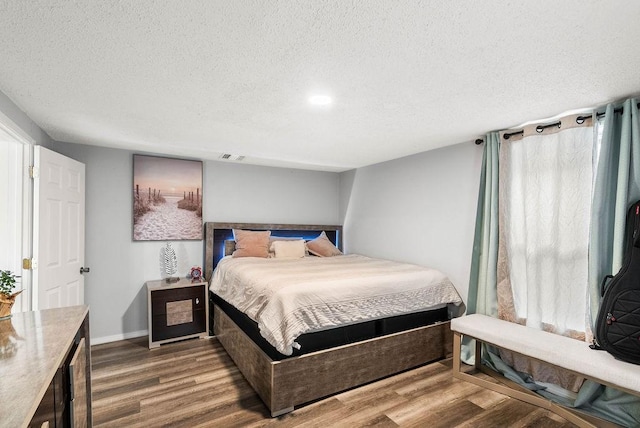 647 W Main Ave, Robstown, TX 78380 - bedroom with a textured ceiling and wood finished floors