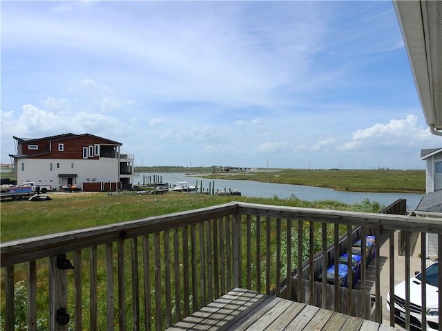 wooden deck featuring a water view