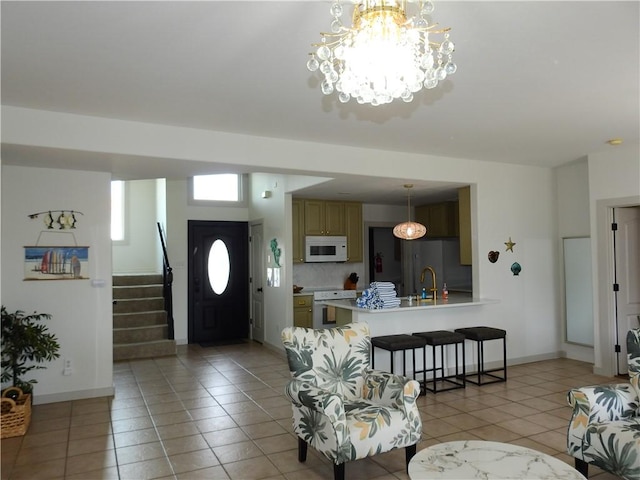 entrance foyer with stairs, light tile patterned floors, and baseboards