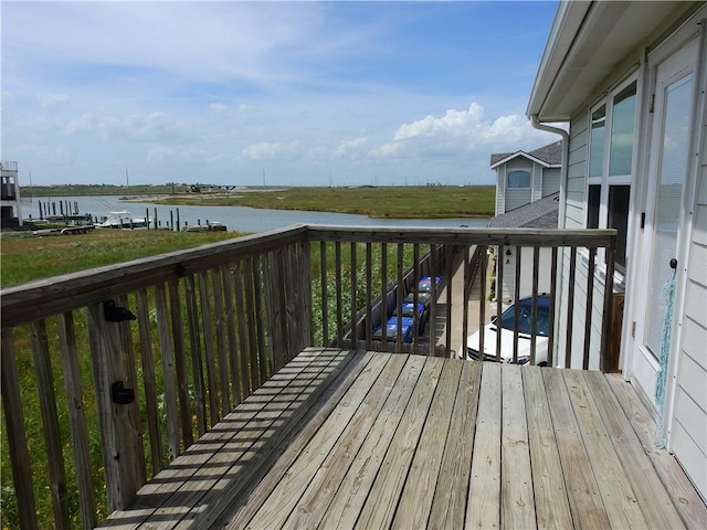 wooden deck featuring a water view