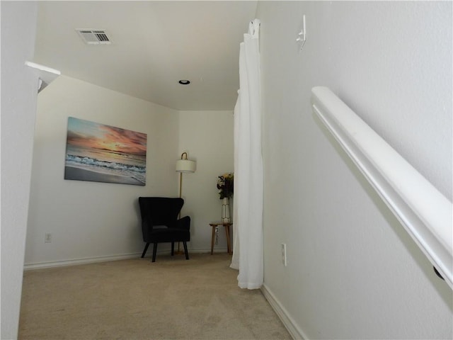 sitting room with light carpet, visible vents, and baseboards