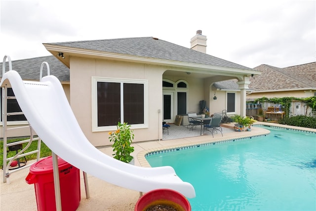 view of swimming pool featuring a patio area and a water slide