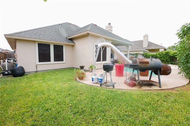 back of property featuring a patio and a lawn