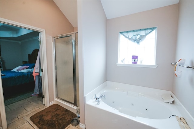 bathroom with shower with separate bathtub, lofted ceiling, and tile patterned floors