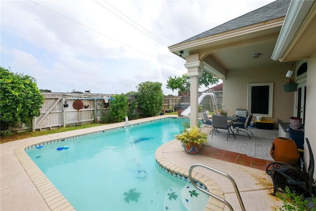 view of swimming pool with a patio area and pool water feature