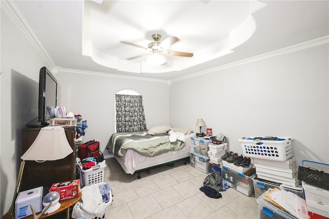 bedroom featuring ornamental molding, ceiling fan, a tray ceiling, and light tile patterned flooring