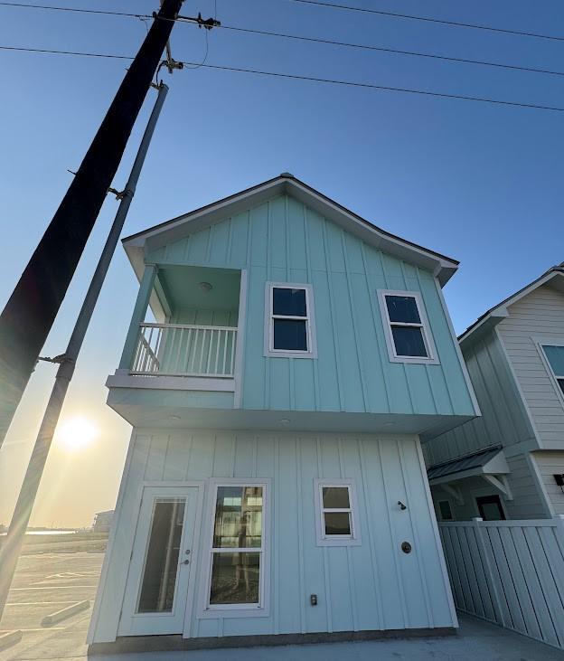 view of home's exterior featuring a balcony and board and batten siding