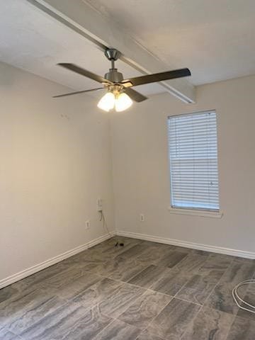 empty room featuring ceiling fan, beamed ceiling, baseboards, and wood finished floors