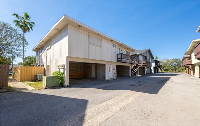 view of property exterior featuring central AC and a garage