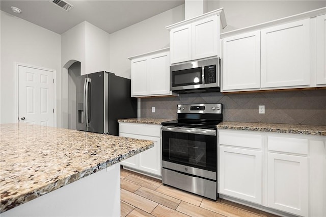 10113 Maverick, Corpus Christi, TX 78410 - kitchen with white cabinets, decorative backsplash, stainless steel appliances, and visible vents