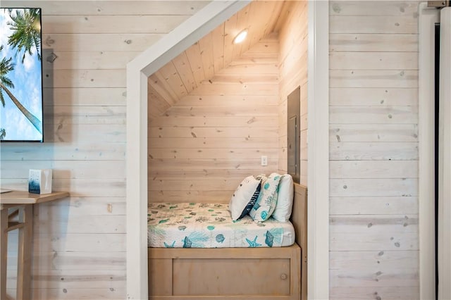 unfurnished bedroom featuring wooden walls