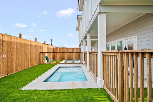 view of pool with a lawn